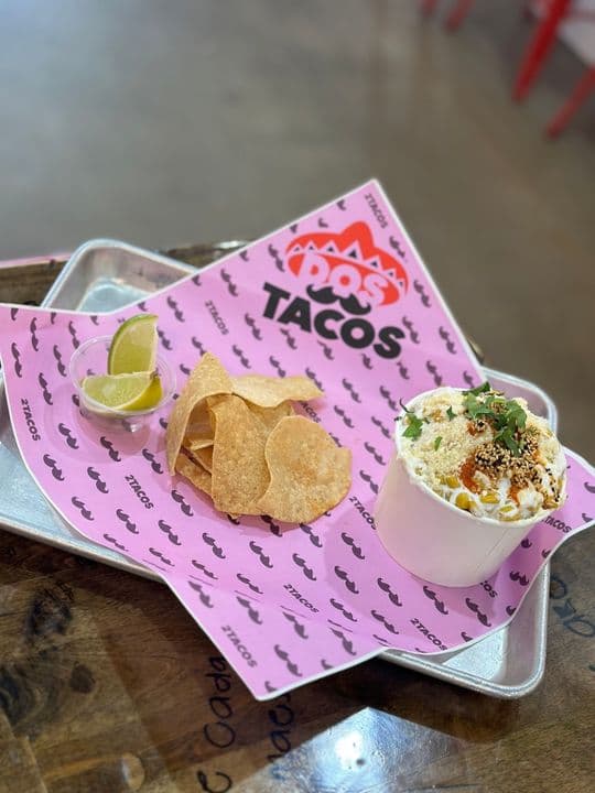 Esquites — grilled corn with crema, cotija and chile