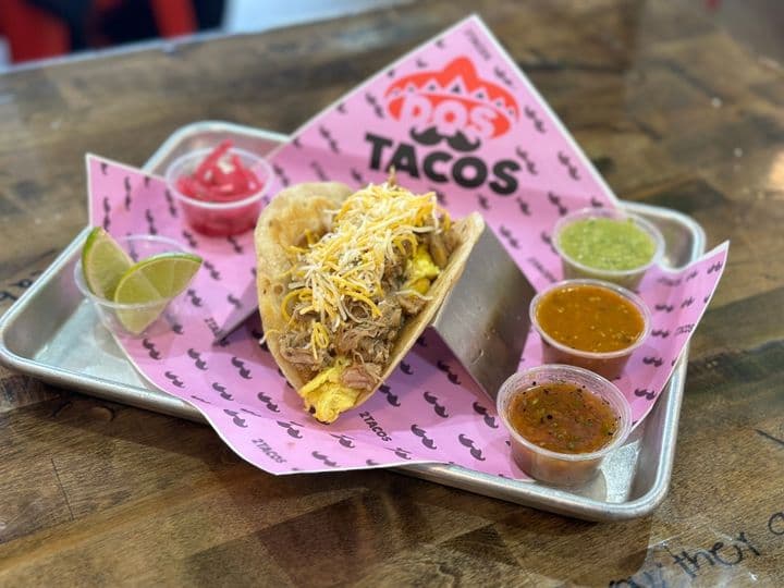 El Pur taco with melted cheese on a Dos Tacos tray