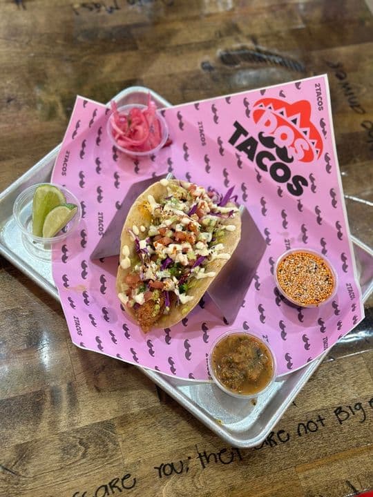 Fish taco topped with pico de gallo